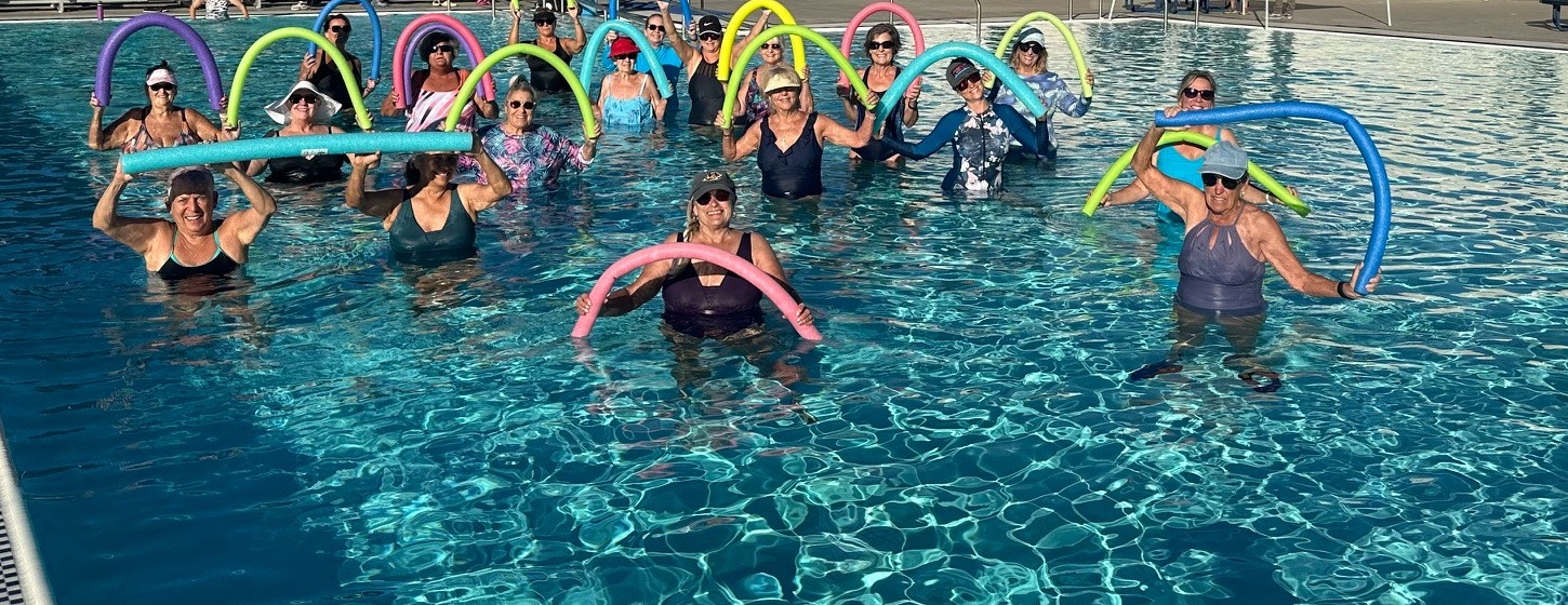 Clouds Rest aqua fitness group holding colorful pool noodles