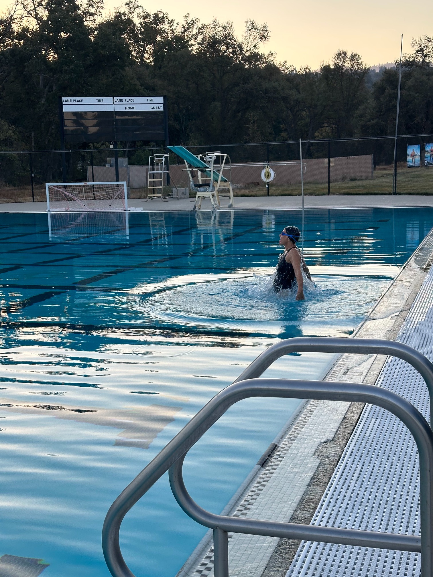Swimmer at the edge of the pool in the evening
