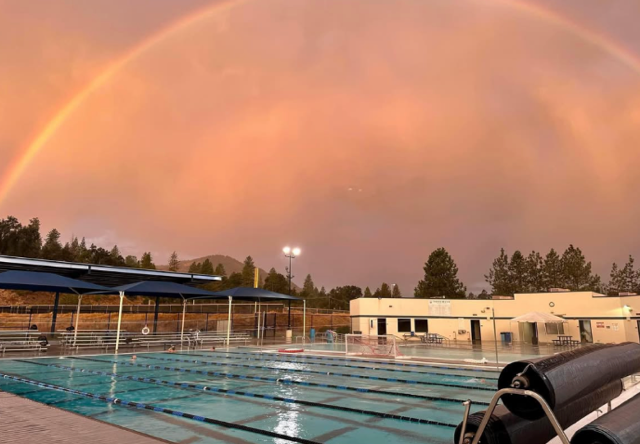 Rainbow over the outdoor pool at dusk