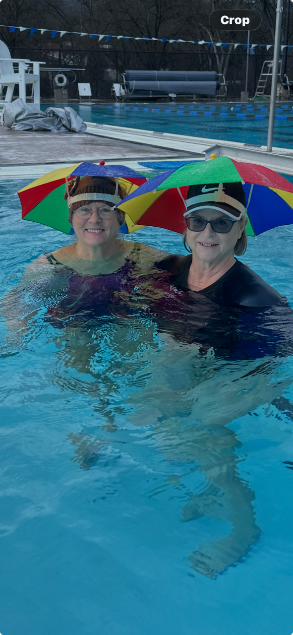 Two Clouds Rest friends having fun in colorful rain hats at the pool