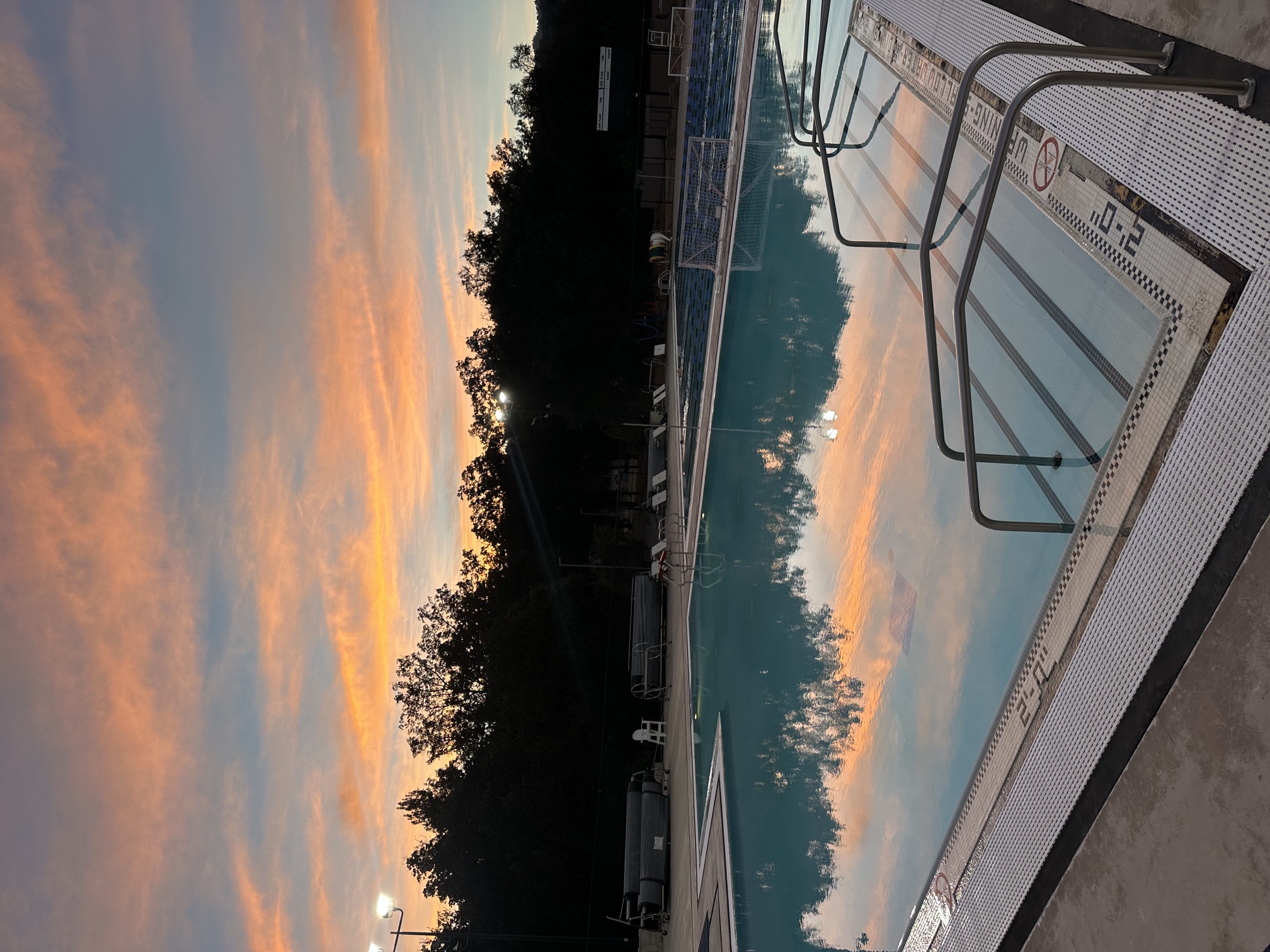 Quiet Clouds Rest pool reflecting a colorful sunrise sky