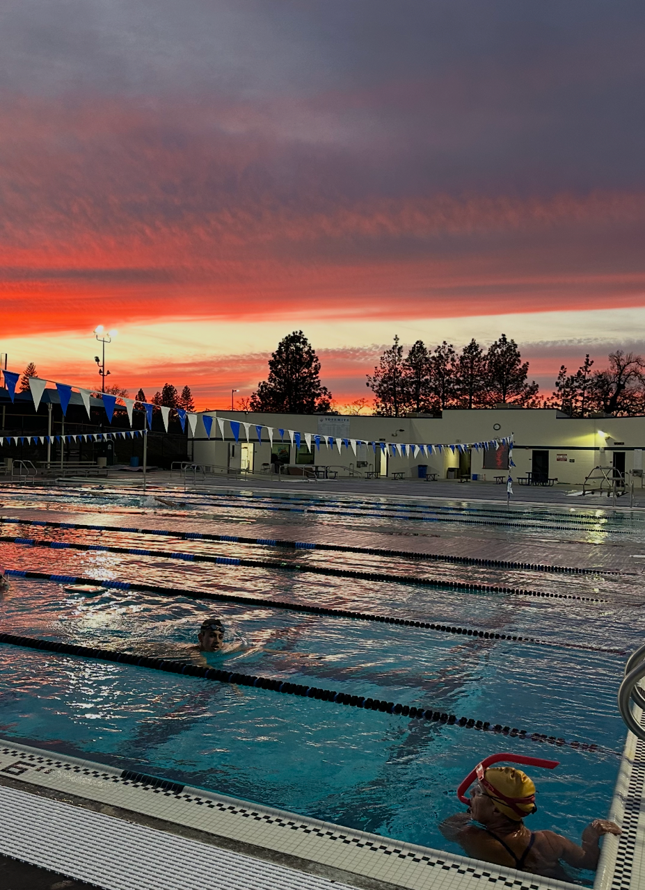 Clouds Rest swimmers beneath a vivid sunset sky